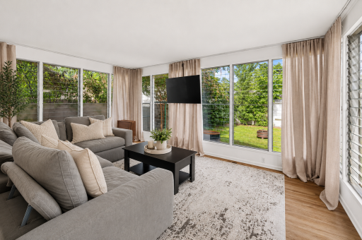 Temperature-controlled four-season sunroom with new luxury vinyl plank flooring. *Virtually Staged*