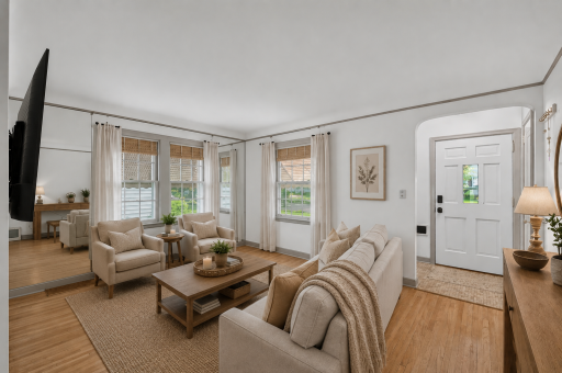 Sun-filled living room featuring beautiful hardwood floors and classic architectural details. *Virtually Staged*