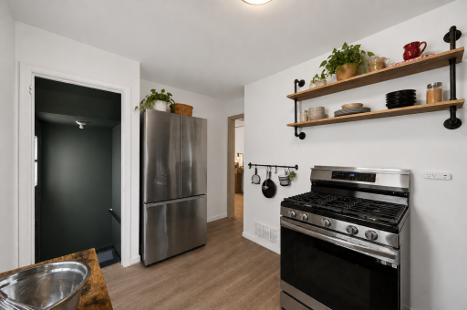 Stainless steel appliances, including a French door refrigerator, blend modern convenience with timeless character.