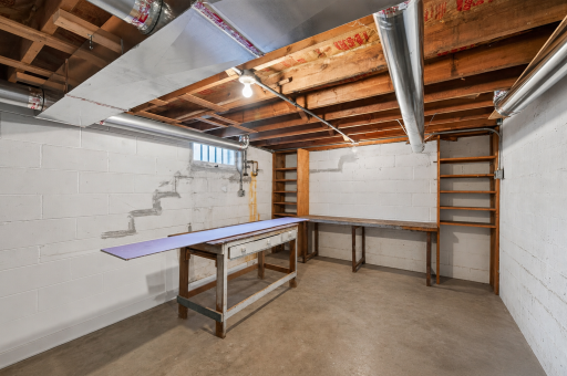 Expansive utility and workshop area provides exceptional storage and project space.