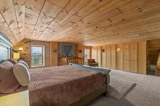 The lofted primary bedroom is both spacious and cozy with built in closets.
