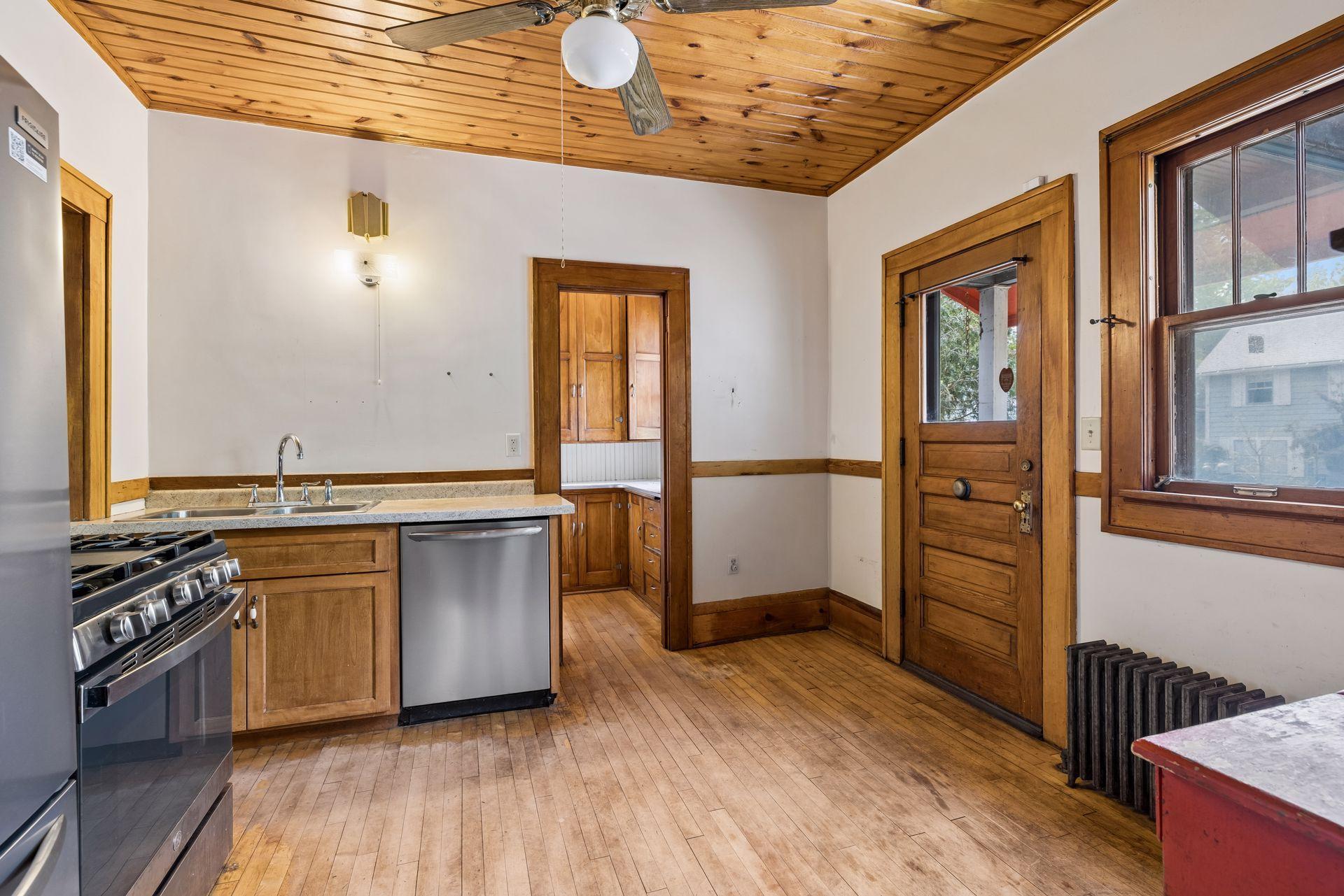 Kitchen with door on left to pantry and door on right to side yard