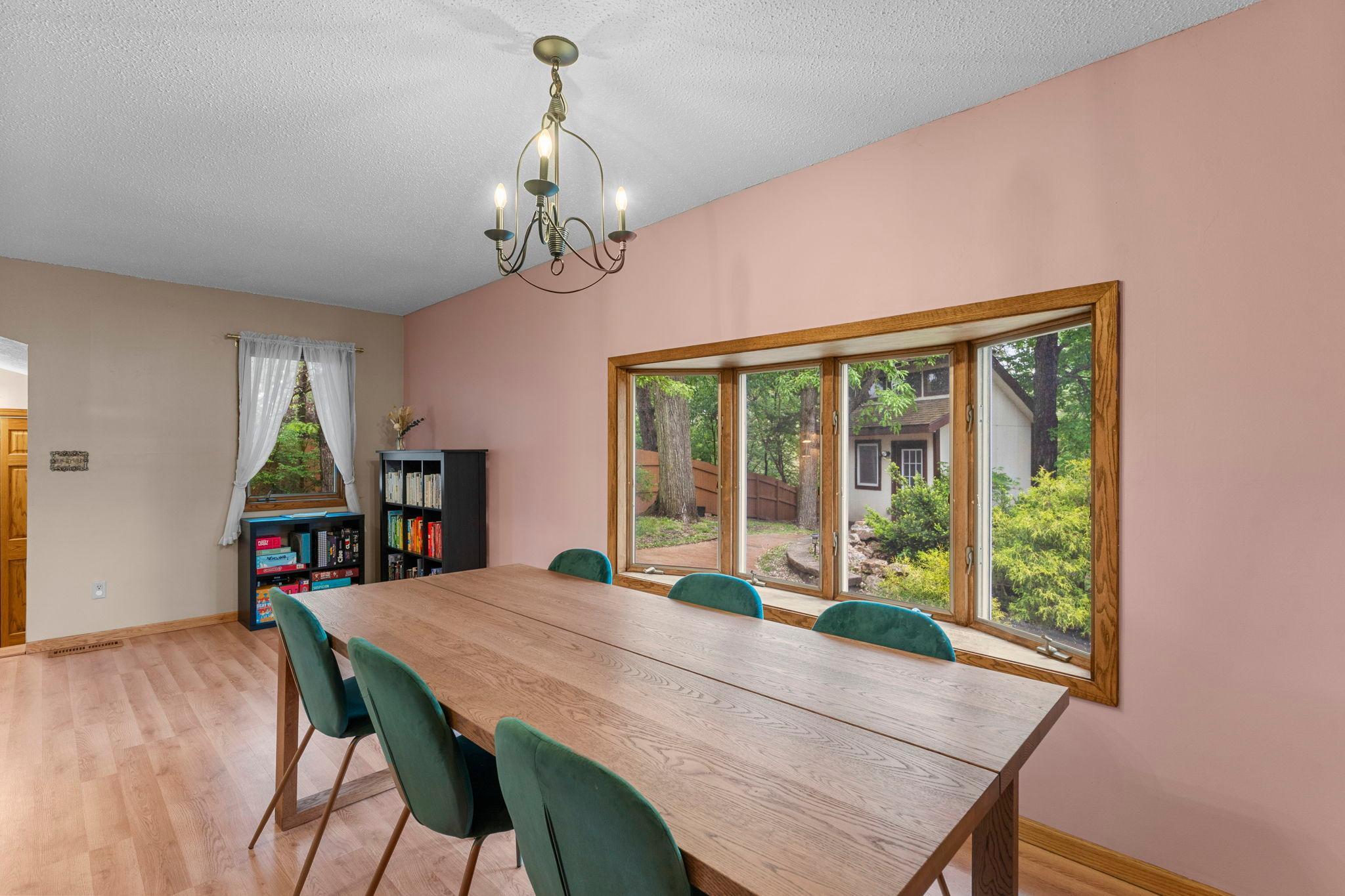 Large dining room space with bay window to backyard