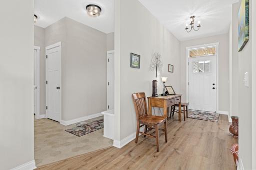 Main entrance to the home, as well as the door and bench coming from the garage.