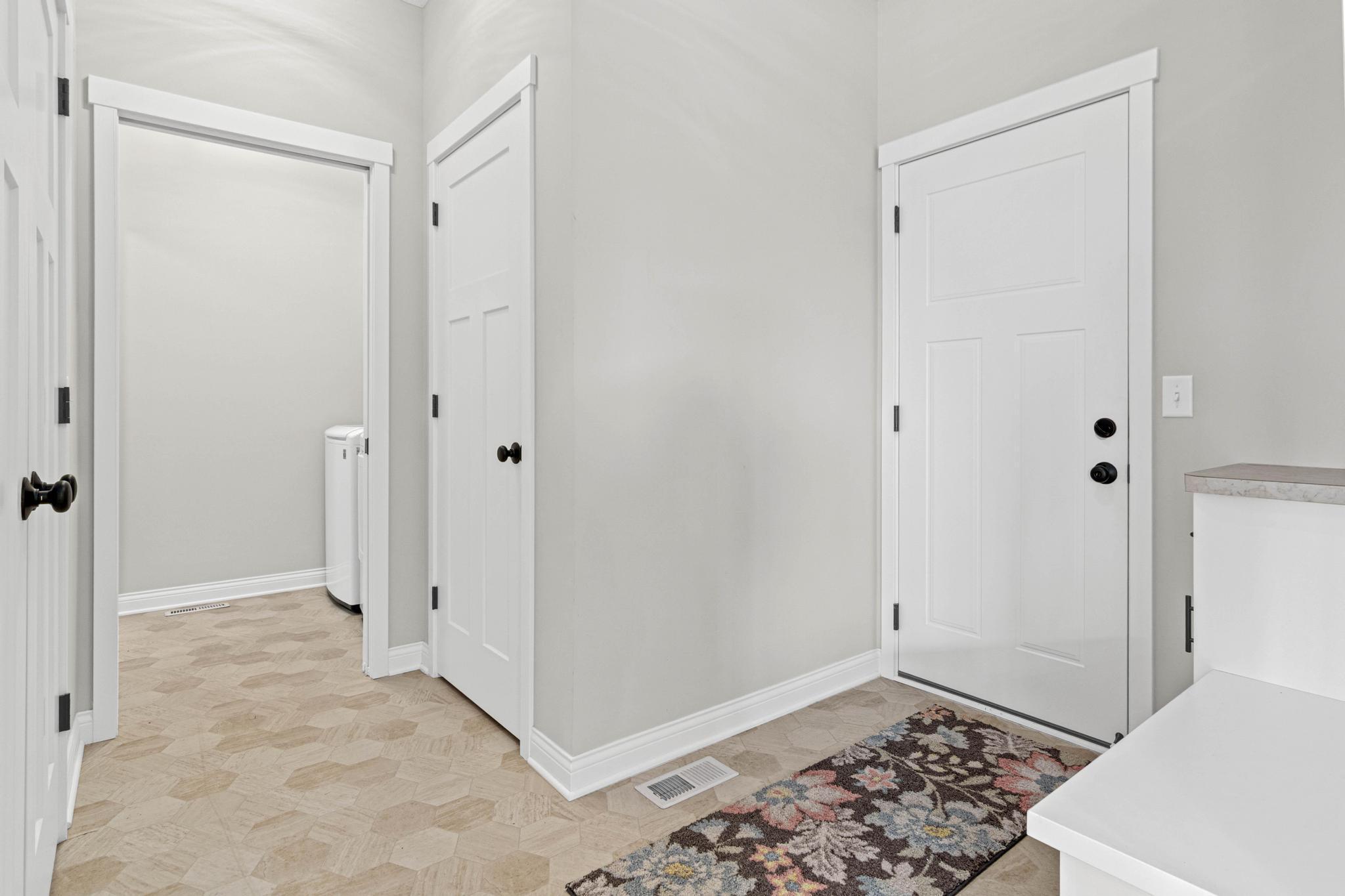 Garage entrance features easily-to-maintain flooring, abundant storage closets and the laundry.