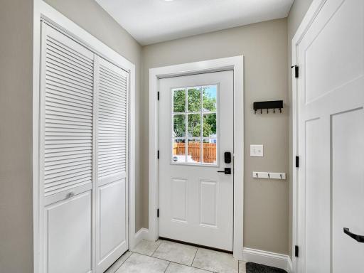 A large pantry and coat closet sit conveniently in the attached mudroom.