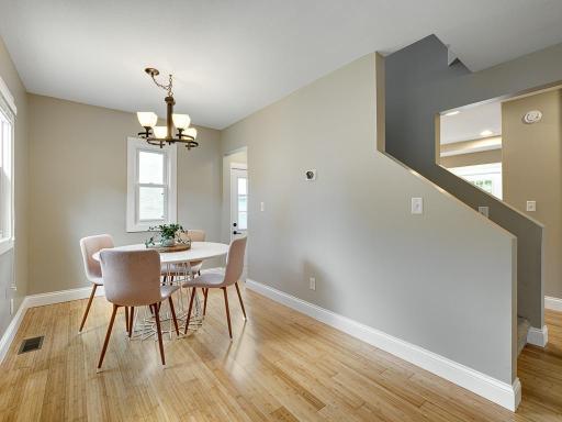 The spacious dining area flows seamlessly from the living room to the kitchen.
