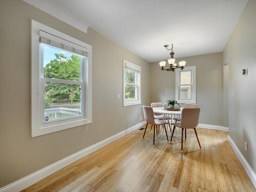 The spacious dining area flows seamlessly from the living room to the kitchen.