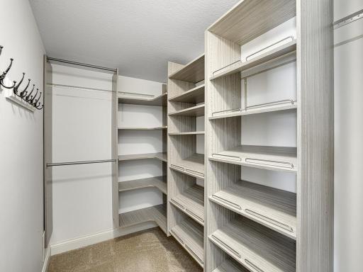 A sleek and stylish walk-in closet upstairs.