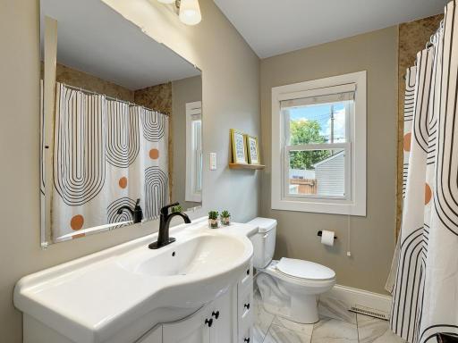 A large vanity is featured in the main level full bathroom.