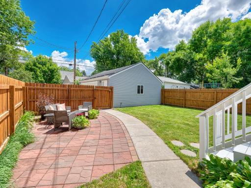 RELAX in your city oasis featuring a freshly painted deck and large patio, all surrounded by a full privacy fence.