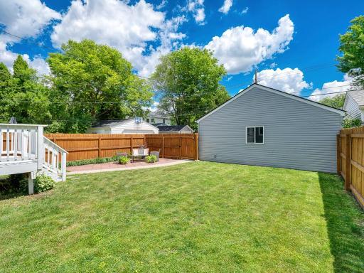 RELAX in your city oasis featuring a freshly painted deck and large patio, all surrounded by a full privacy fence.