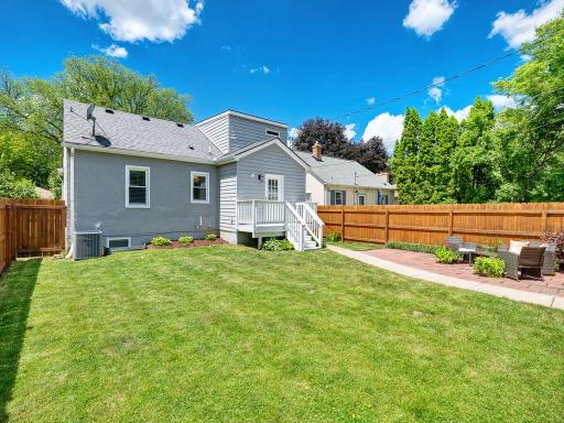 RELAX in your city oasis featuring a freshly painted deck and large patio, all surrounded by a full privacy fence.