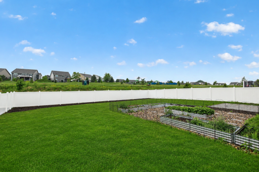 Lovely fenced yard with beautifully maintained garden.