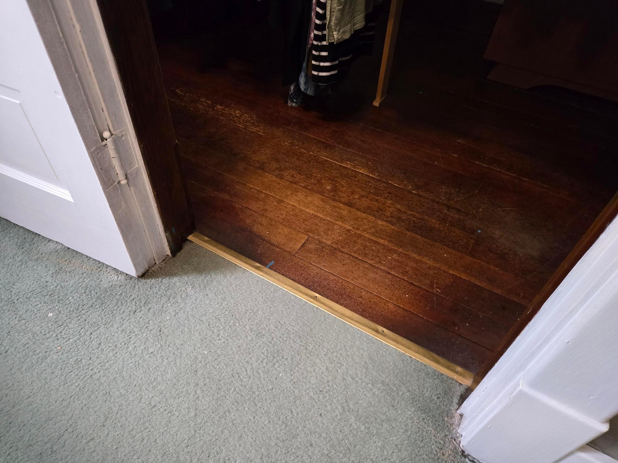 Peek of beautiful hardwood floors in primary bedrooms closet!