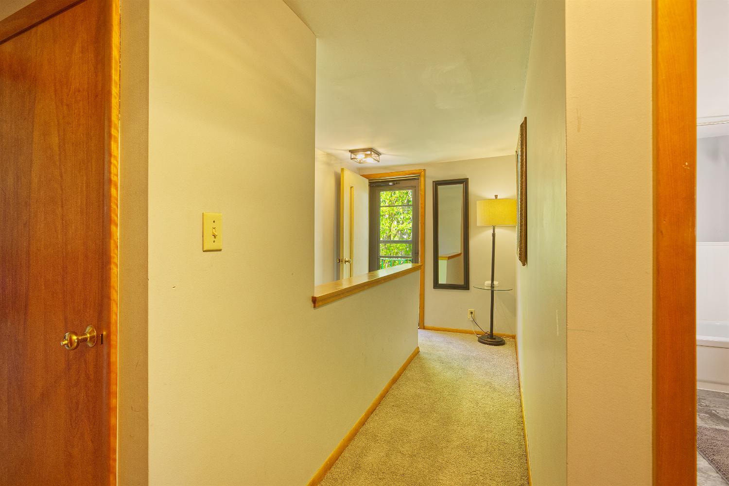 Upper level hallway to door to small step out balcony
