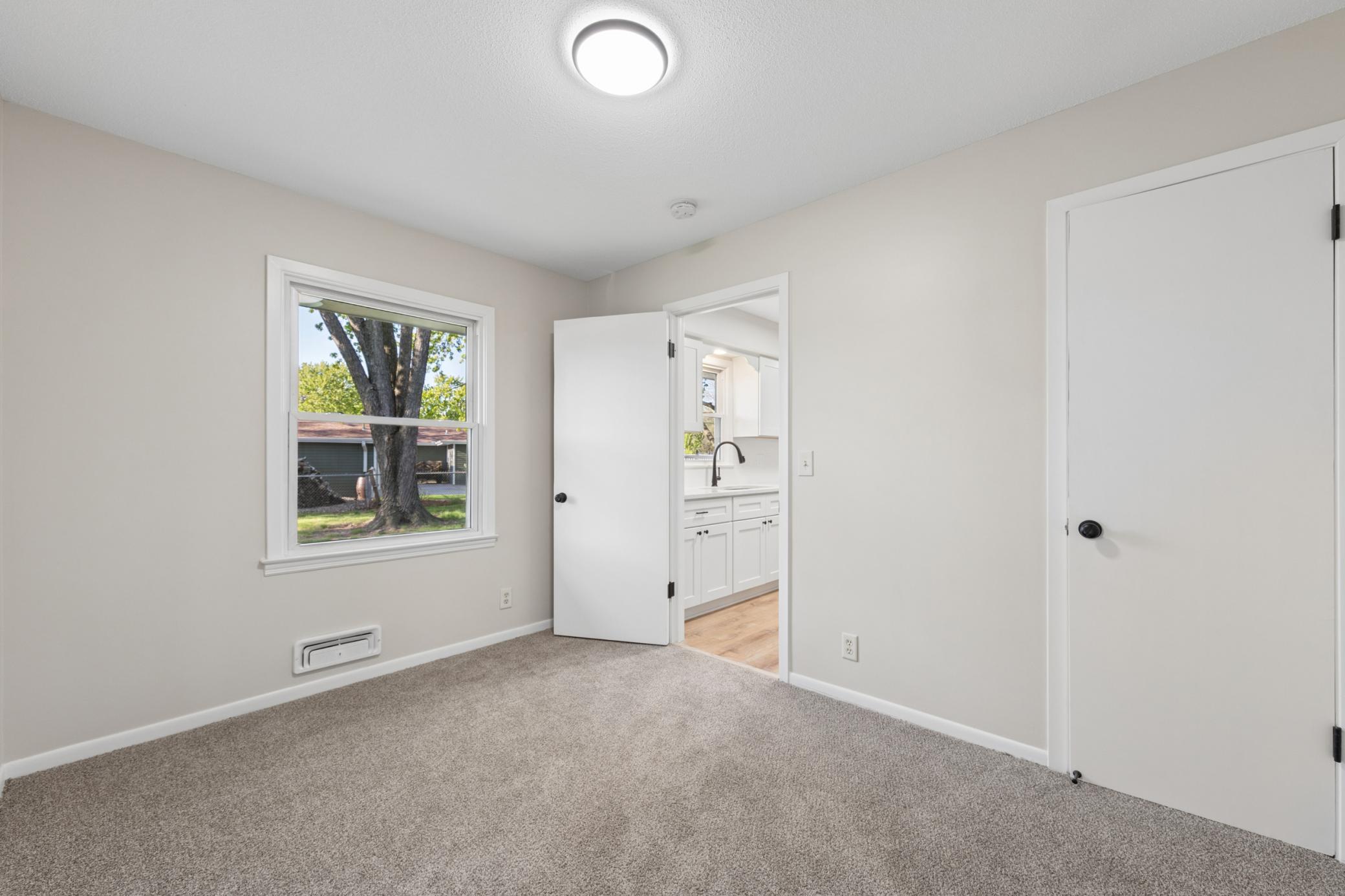 1 of 4 main floor bedrooms walks into the kitchen & the hall, could be a dining room