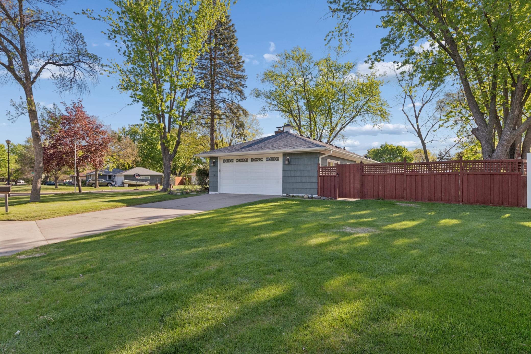 Oversized 2 car garage has 624 square feet concrete driveway plus an extra parking pad behind the fence