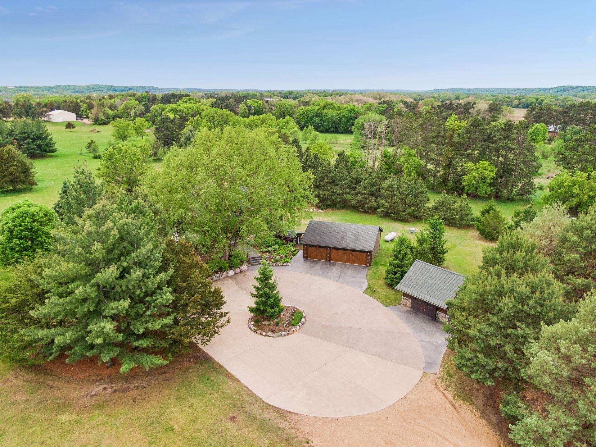 Three car garage with concrete roundabout, plenty of storage onsite.
