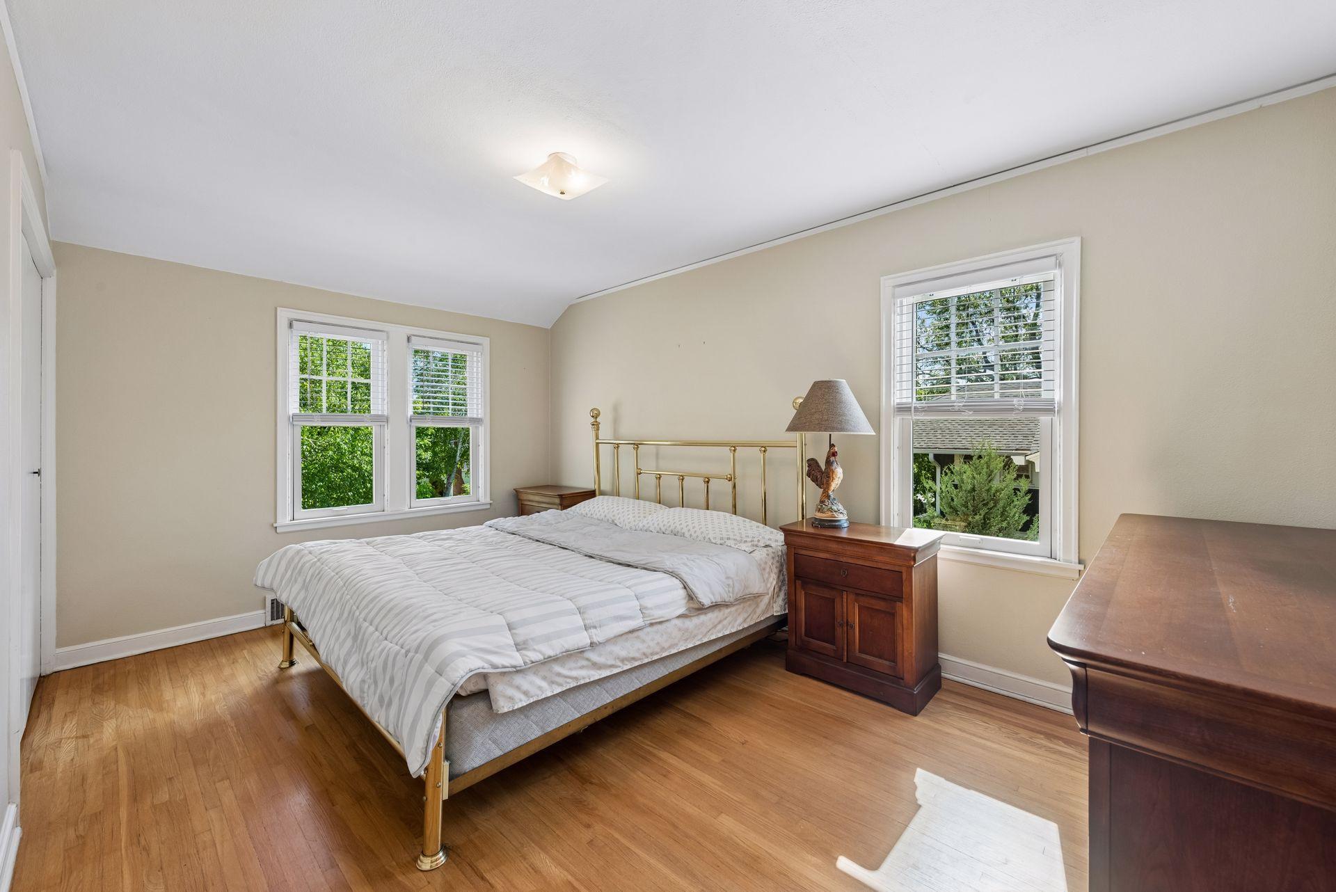 Huge primary bedroom with wood flooring and cross ventilation