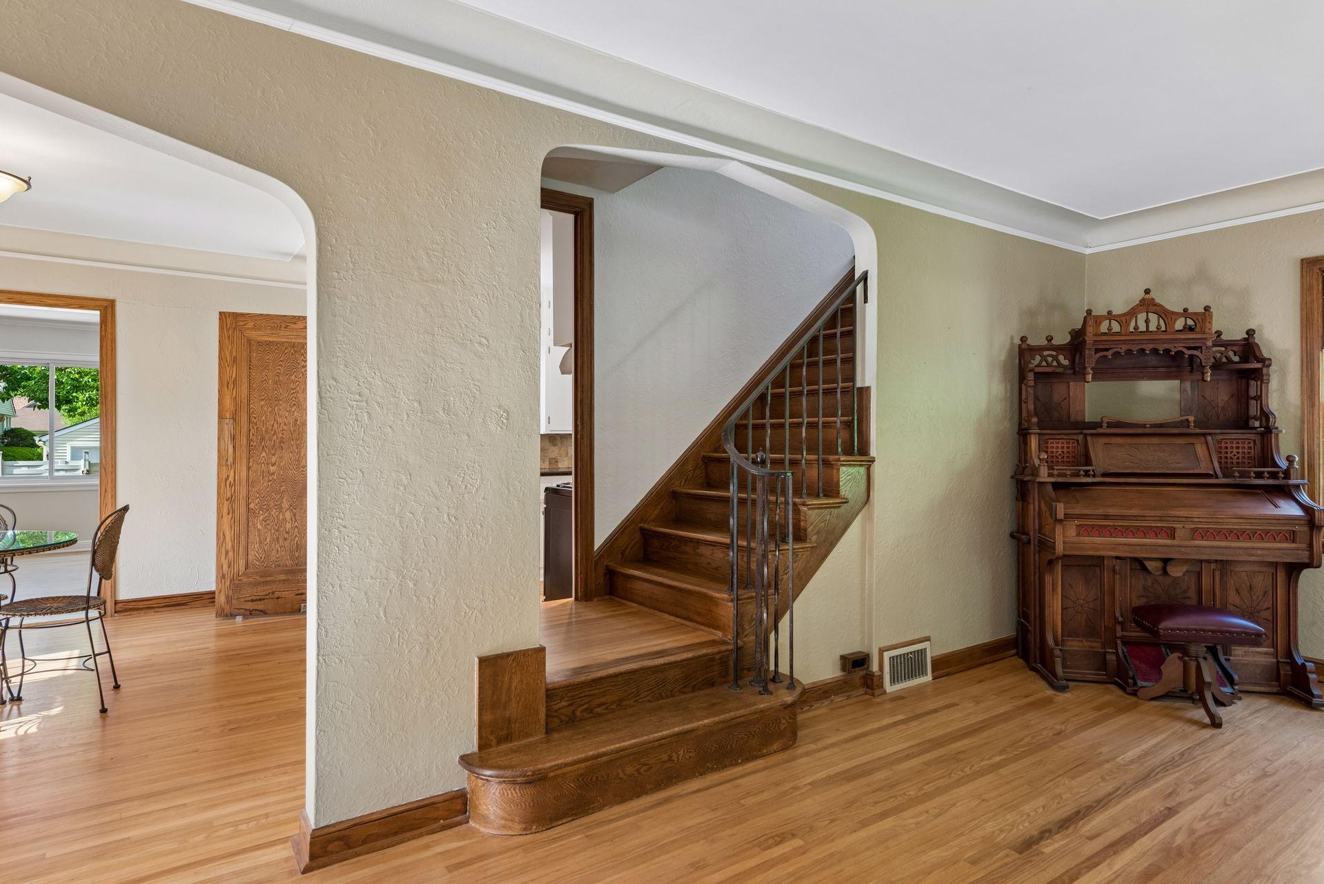 Beautiful wooden stairs with railing and coved ceiling