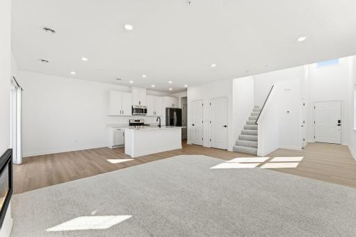 (Photo of a similar home, actual finishes may vary) This Great Room is framed by windows to bathe the space in natural light