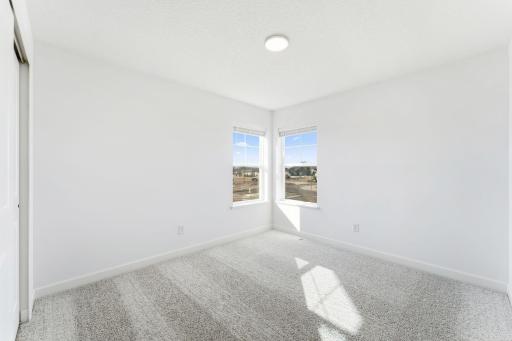 (Photo of a similar home, actual finishes may vary) The upper-level secondary bedrooms are perfectly situated away from the downstairs main living areas and are blank canvases ready to be personalized.