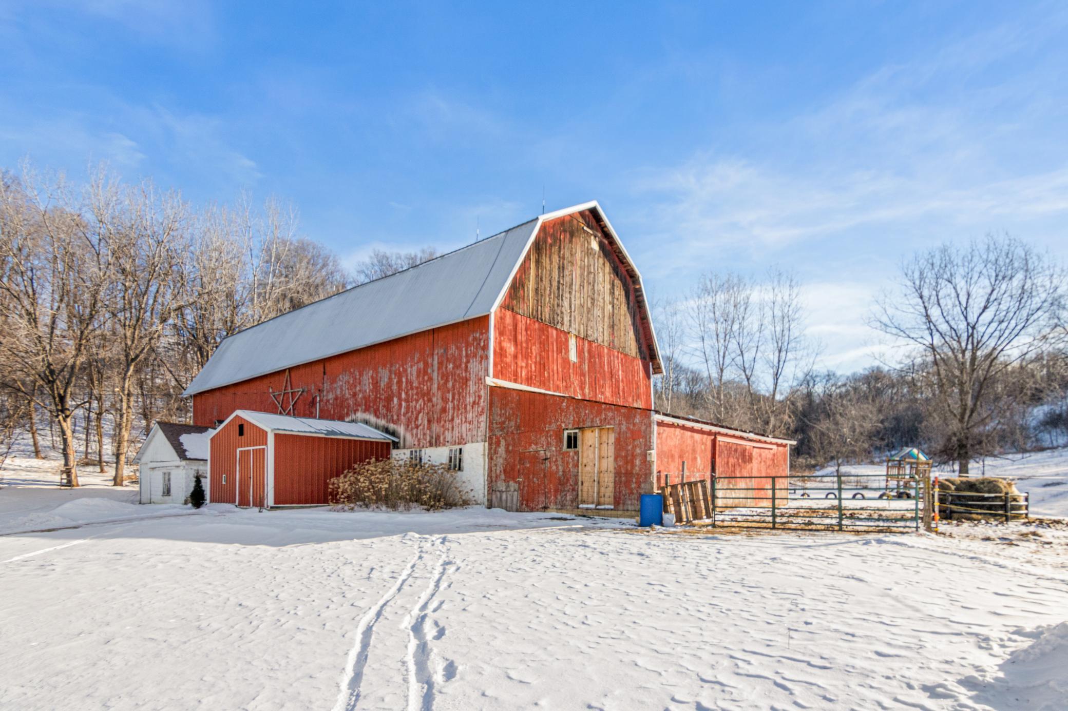 The red barn stands ready for animals, hobbies, or storage