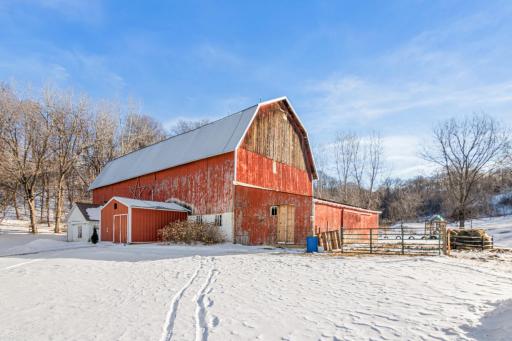 The red barn stands ready for animals, hobbies, or storage