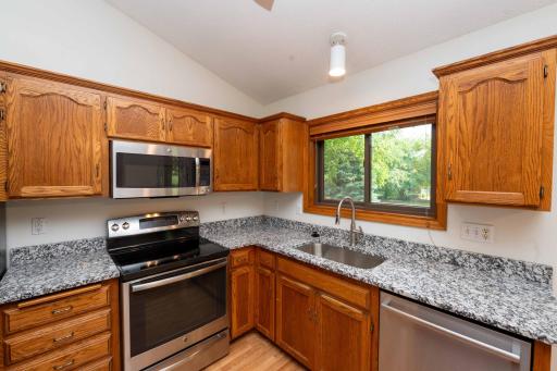 The new granite countertops provide generous prep space, complimented by stainless steel appliances and abundant natural light.