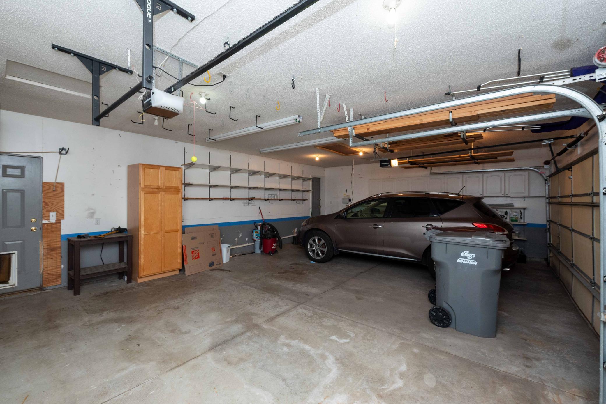 Three car garage with room for all your toys. This space lives bigger than you think.”