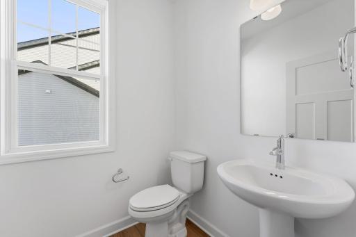 Conveniently placed near the Great Room, the powder room is conveniently trucked away with privacy in mind.