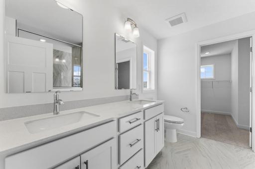 The en-suite bathroom has dual sinks to simplify any morning routine