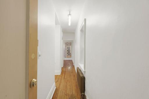 Entrance to the condo, highlighting the wood floors