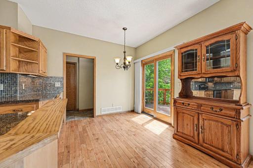 Step right out to your backyard oasis! This sliding door connects the kitchen area directly to the expansive deck, creating an effortless flow that is absolutely perfect for weekend barbecues and entertaining guests.