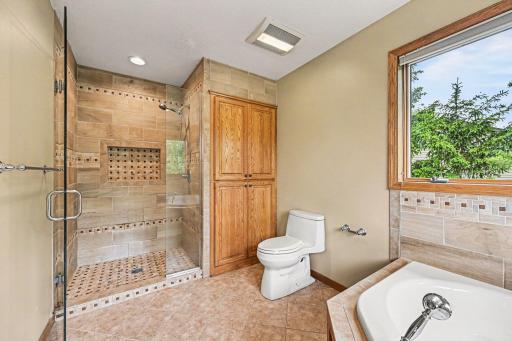 Spa-like features at every turn. This view showcases the primary bathroomâs ceramic tile shower with a glass door, paired with a massive double linen closet that maximizes your storage space.