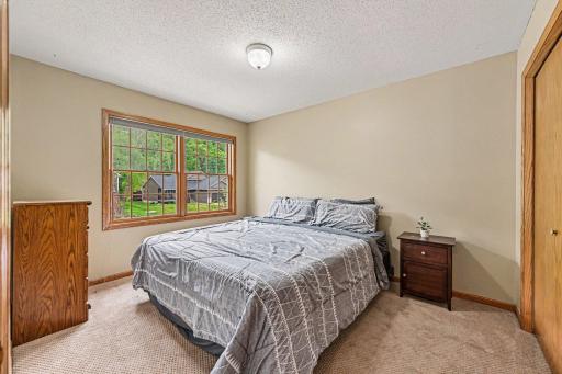 Bedroom two on the upper level features a large front window and a large closet.