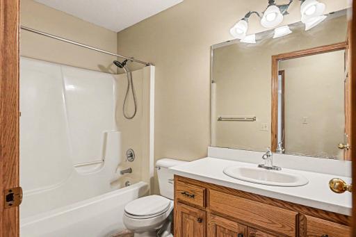 The upper level also includes a convenient full bathroom to service the other two bedrooms. Perfect for family or guests, this space ensures everyone upstairs has plenty of room to get ready in the morning.