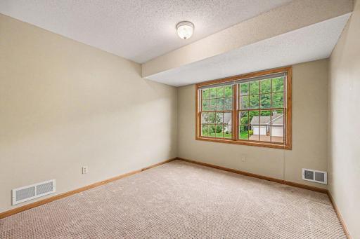 Bedroom three on the upper level features a large front window and a large closet.