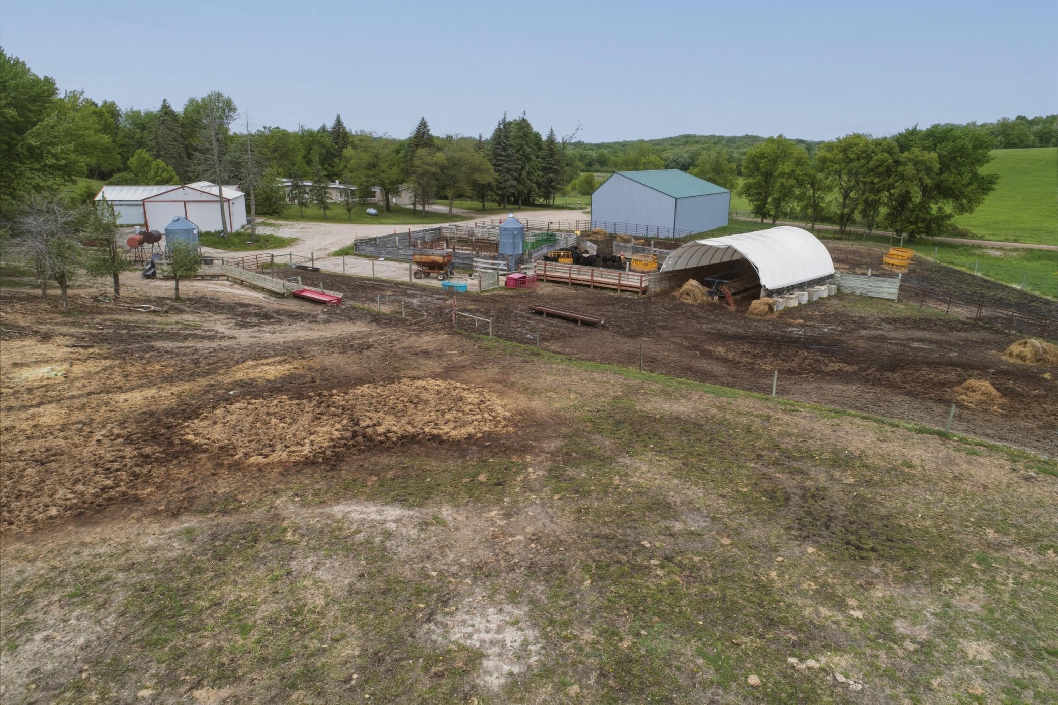 White structure (hoop barn) with tar floor