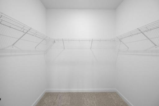 A mesh shelf in the walk-in closet provides wardrobe organization