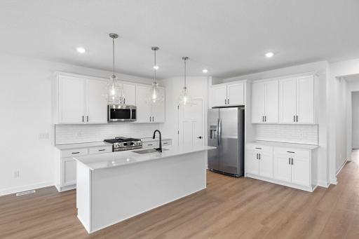 The kitchen features brand-new appliances, ample cabinetry, designer-selected countertops and a pantry for added storage space.