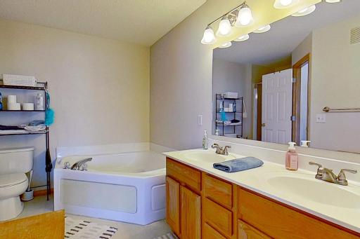 Upper level bathroom with corner tub and separate shower