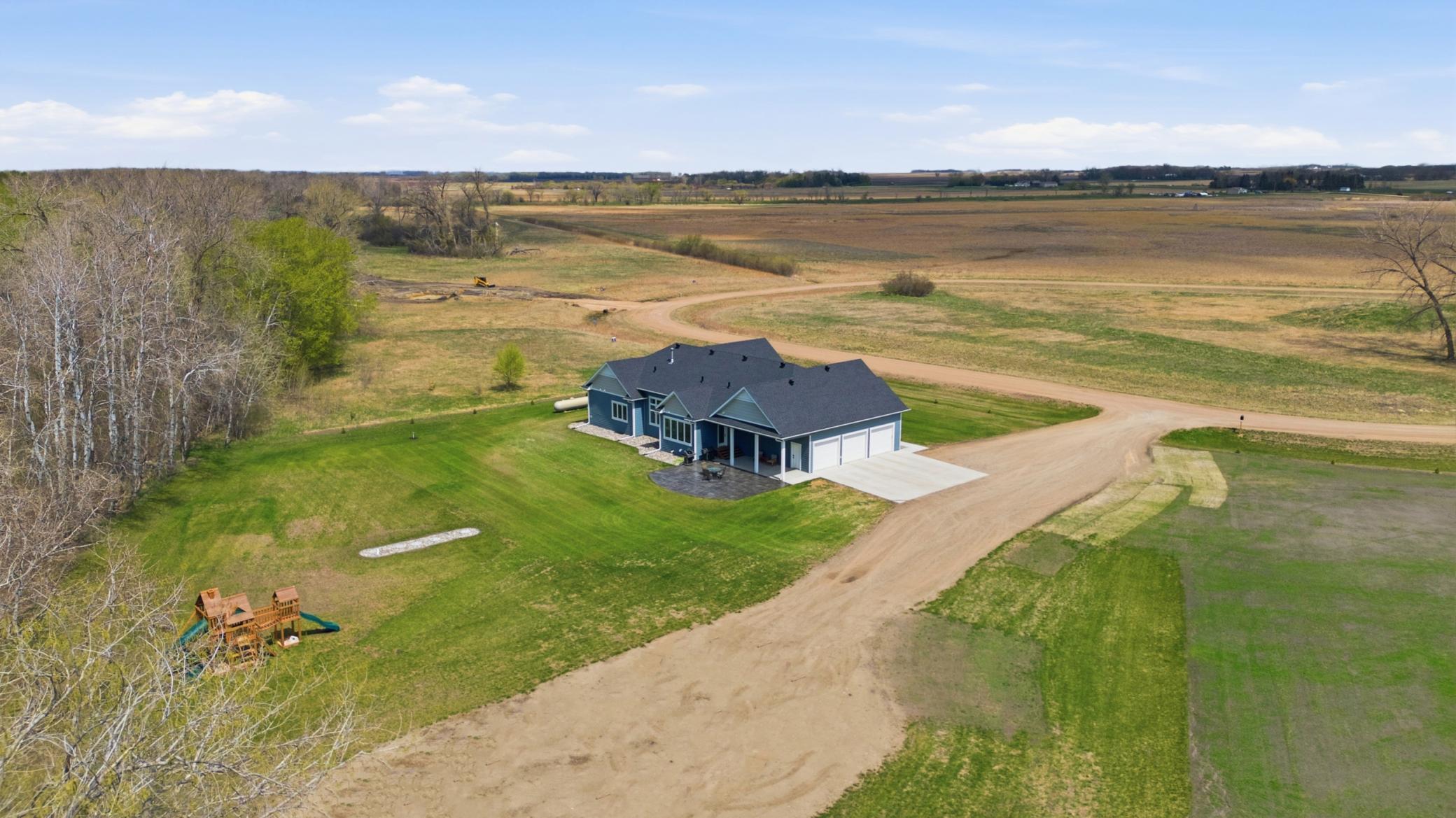 Aerial View - Driveway to gravel pad for future outbuilding. Power/water ready.