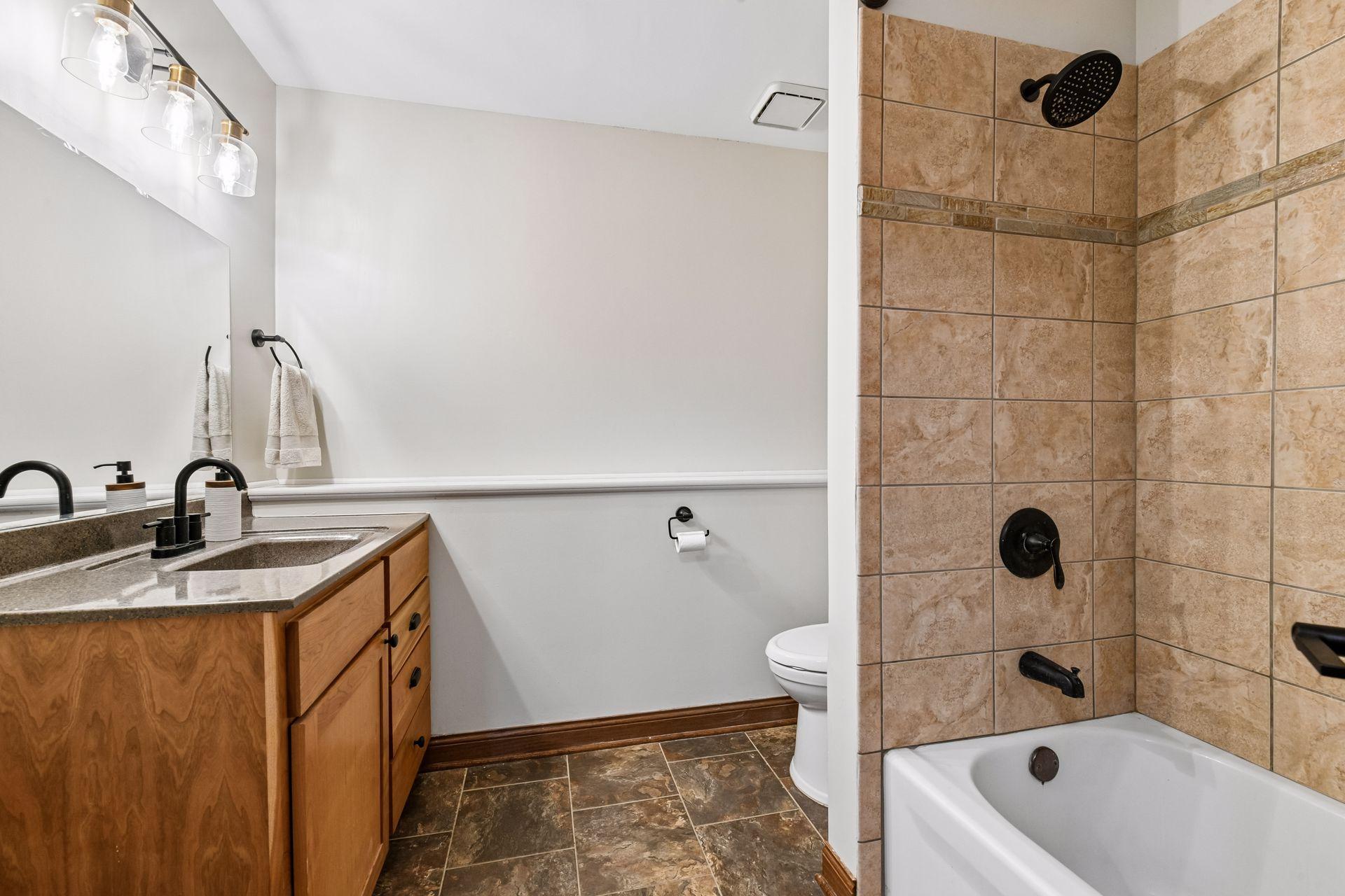 The full bathroom in the lower level features in-floor heating and a comfort height vanity.