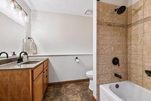The full bathroom in the lower level features in-floor heating and a comfort height vanity.