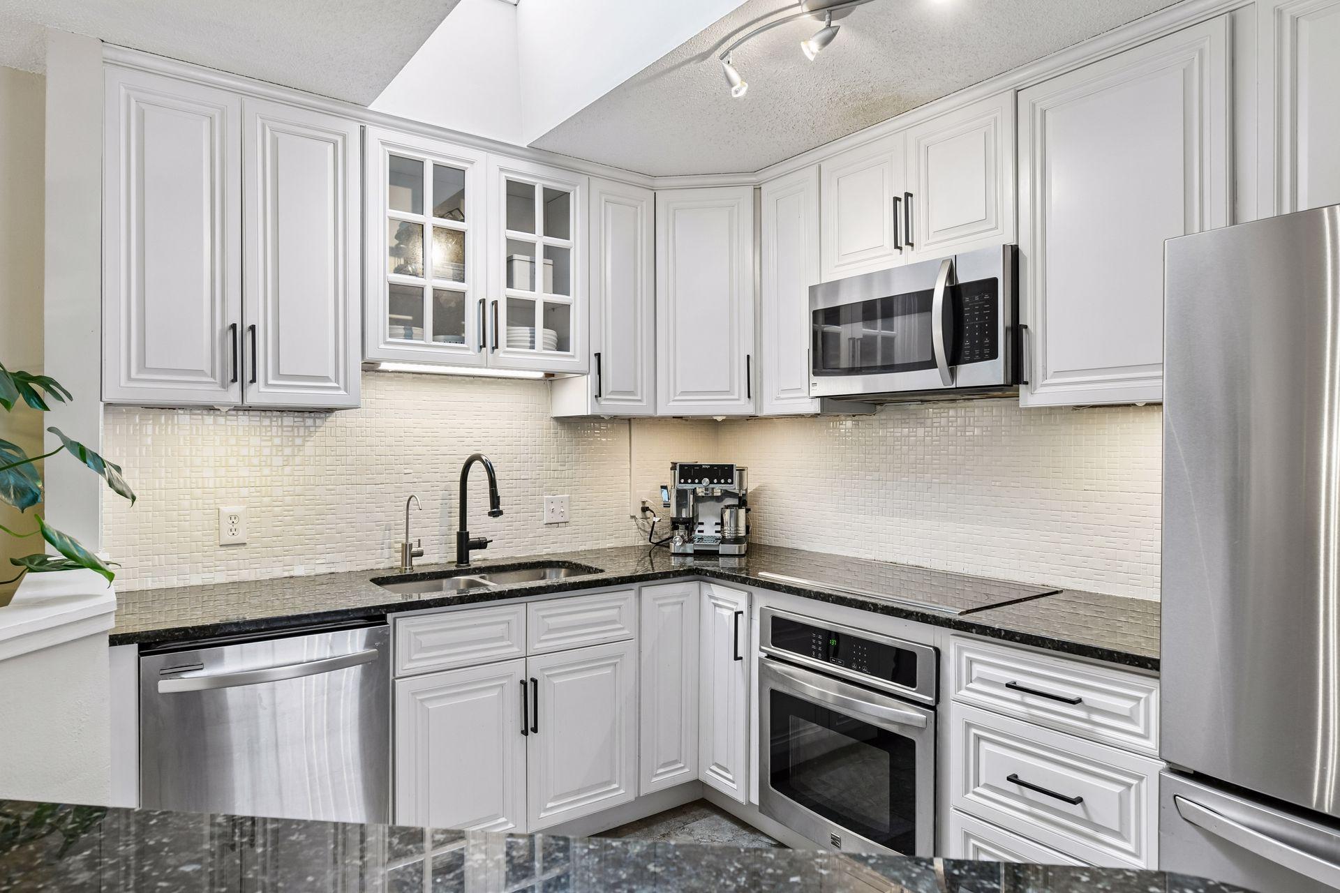 A skylight fills the Kitchen with natural light - enjoy stainless steel appliances including a new refrigerator and microwave.