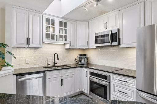 A skylight fills the Kitchen with natural light - enjoy stainless steel appliances including a new refrigerator and microwave.