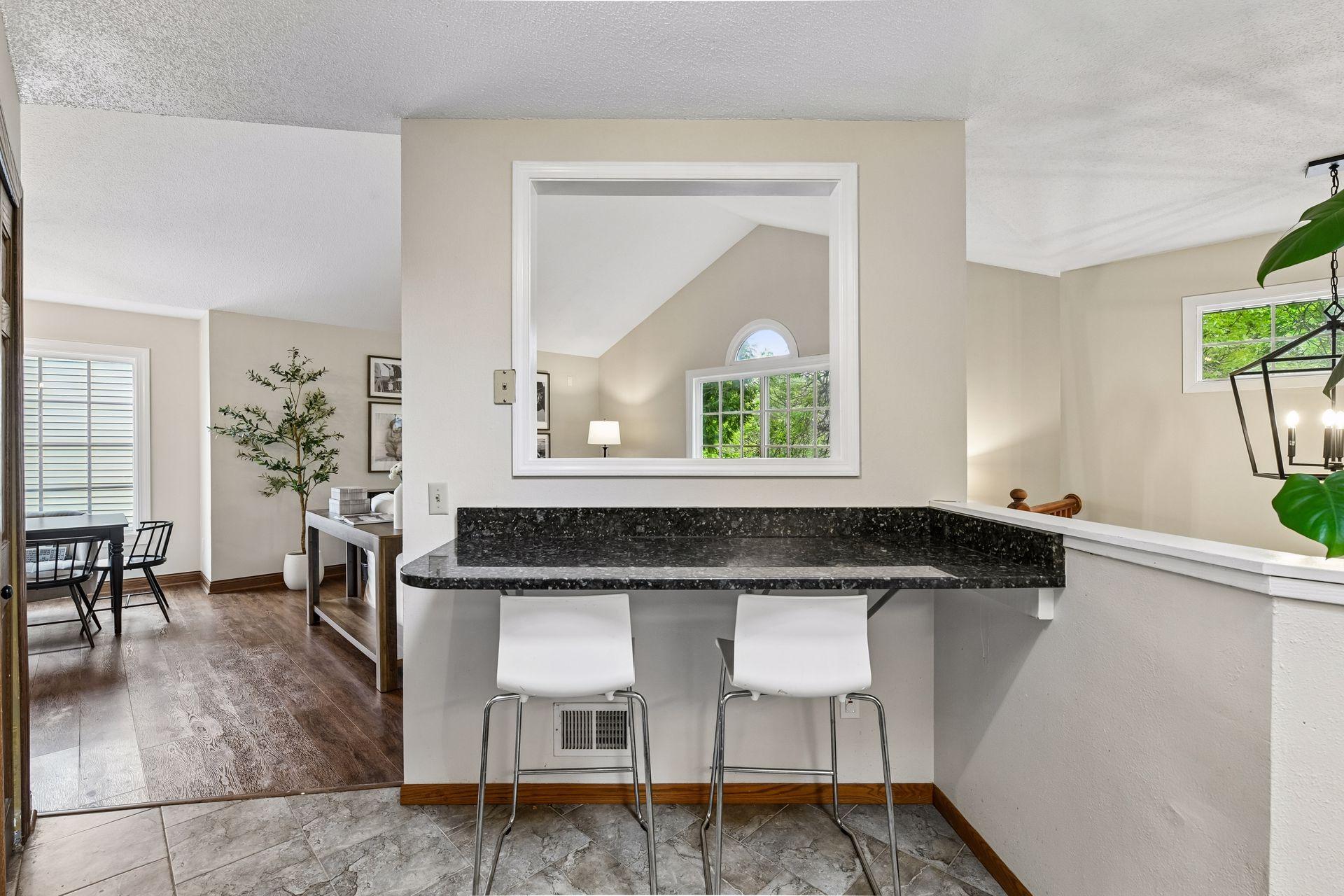 A granite breakfast bar is perfect for a quick morning bite. You'll also enjoy a pantry for added storage.