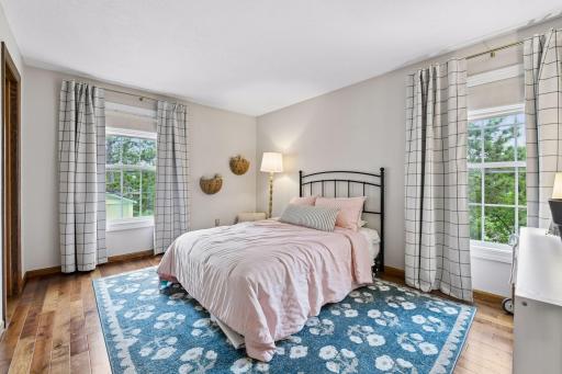 The primary suite enjoys beautiful hardwood floors and a spacious walk-in closet.
